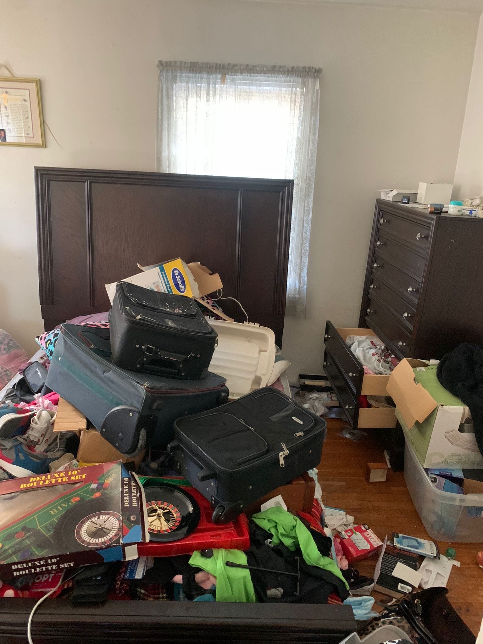 Bedroom packed with suitcases, boxes and household items during a Northern Virginia furniture cleanout