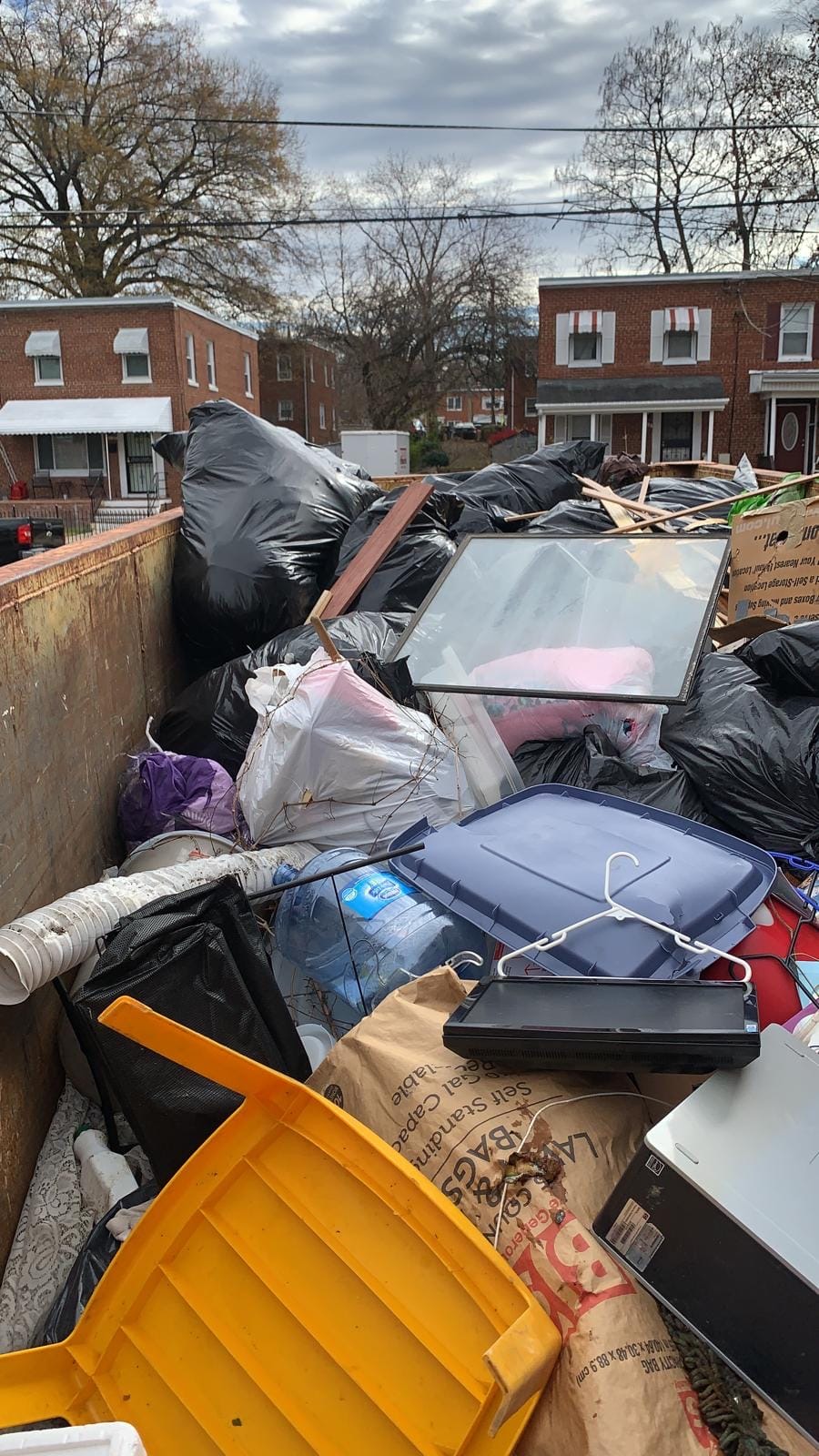 Household junk packed into the Dominion Haul Co truck after a residential pickup in Northern Virginia